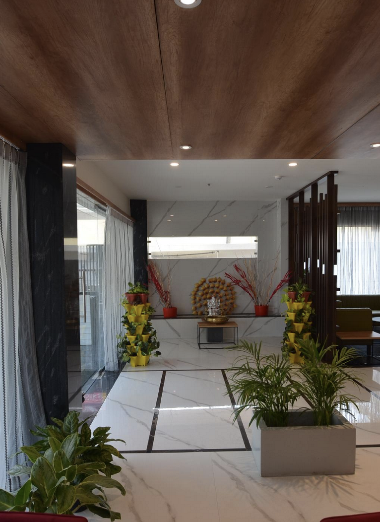 Iva By SKR hotel entrance lobby with marble flooring and wooden ceiling